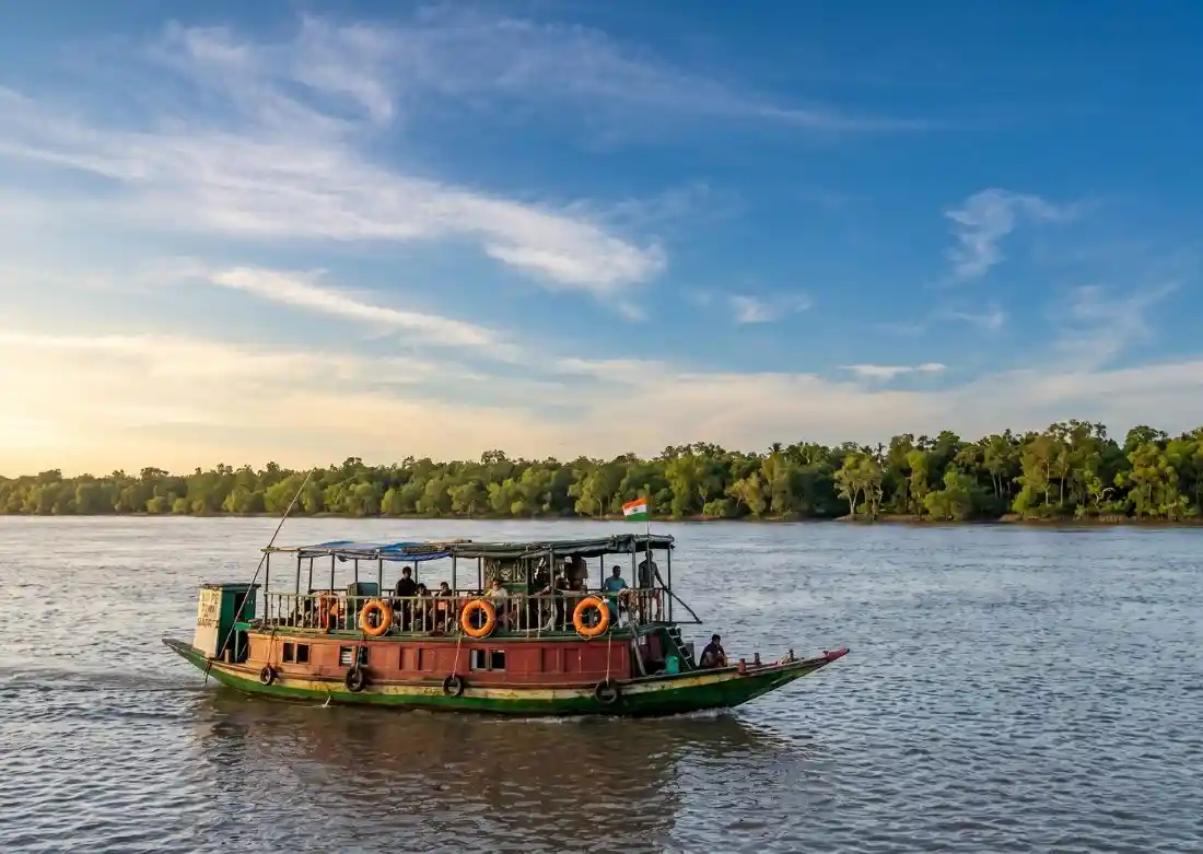 Tourist boat sailing through Sundarban mangrove river during Sundarban tour package safari experience