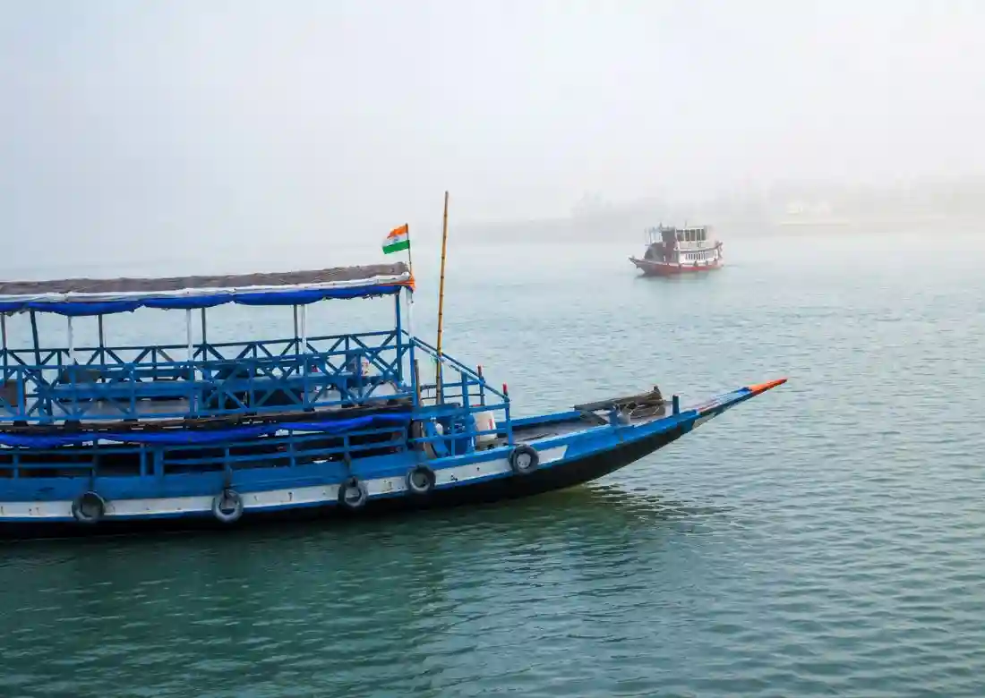 Sundarban cruise agency boat cruising through river with scenic mangrove landscape views